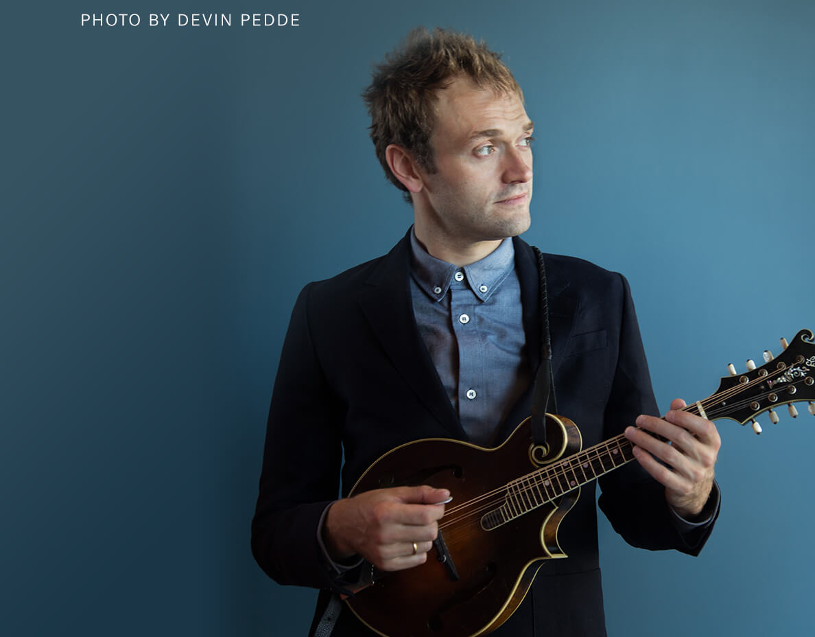 Chris Thile holding mandolin